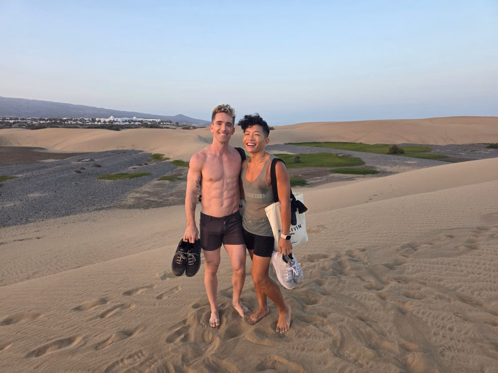 Mark and Beatus standing together in the Maspalomas dunes at dusk.