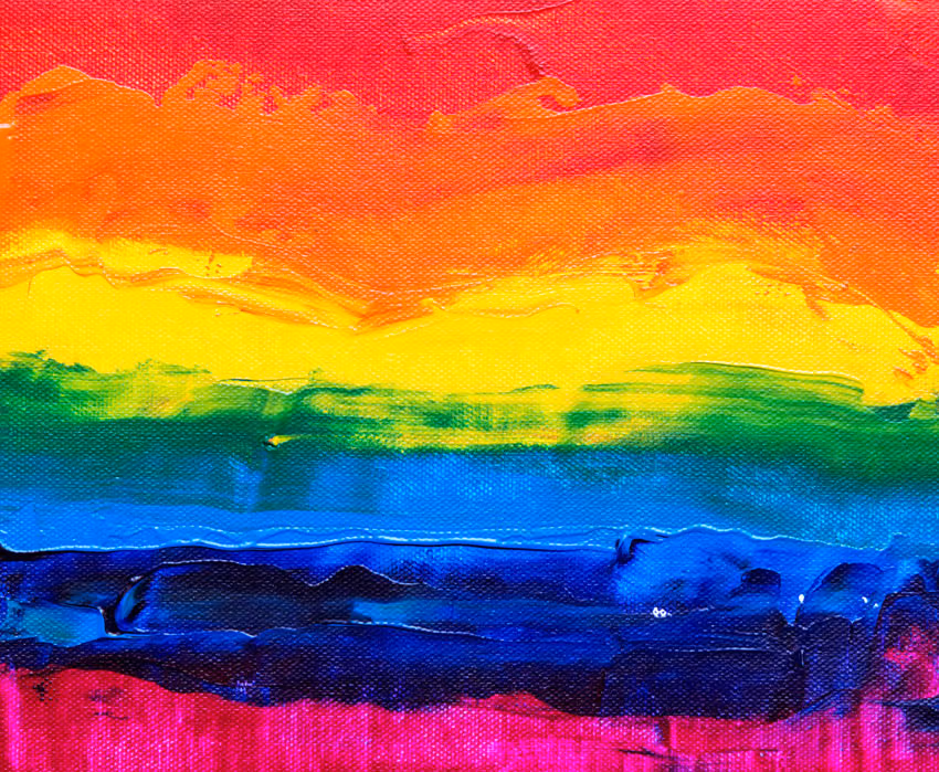 Abstract acrylic painting of thick rainbow brushstrokes in red, orange, yellow, green, blue and pink