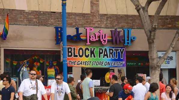 Block Party WeHo storefront, signed "The gayest store on Earth," with shoppers on the sidewalk