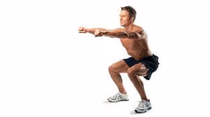 Man doing a bodyweight squat with his arms extended in front of him