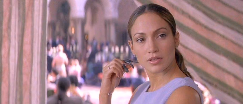 Jennifer Lopez in The Wedding Planner, holding a headset at a wedding venue