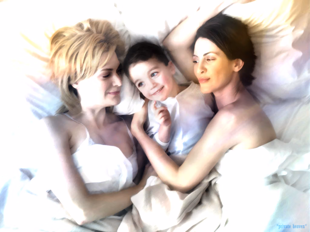 Queer As Folk's Lindsay and Melanie lying in bed with their young son between them