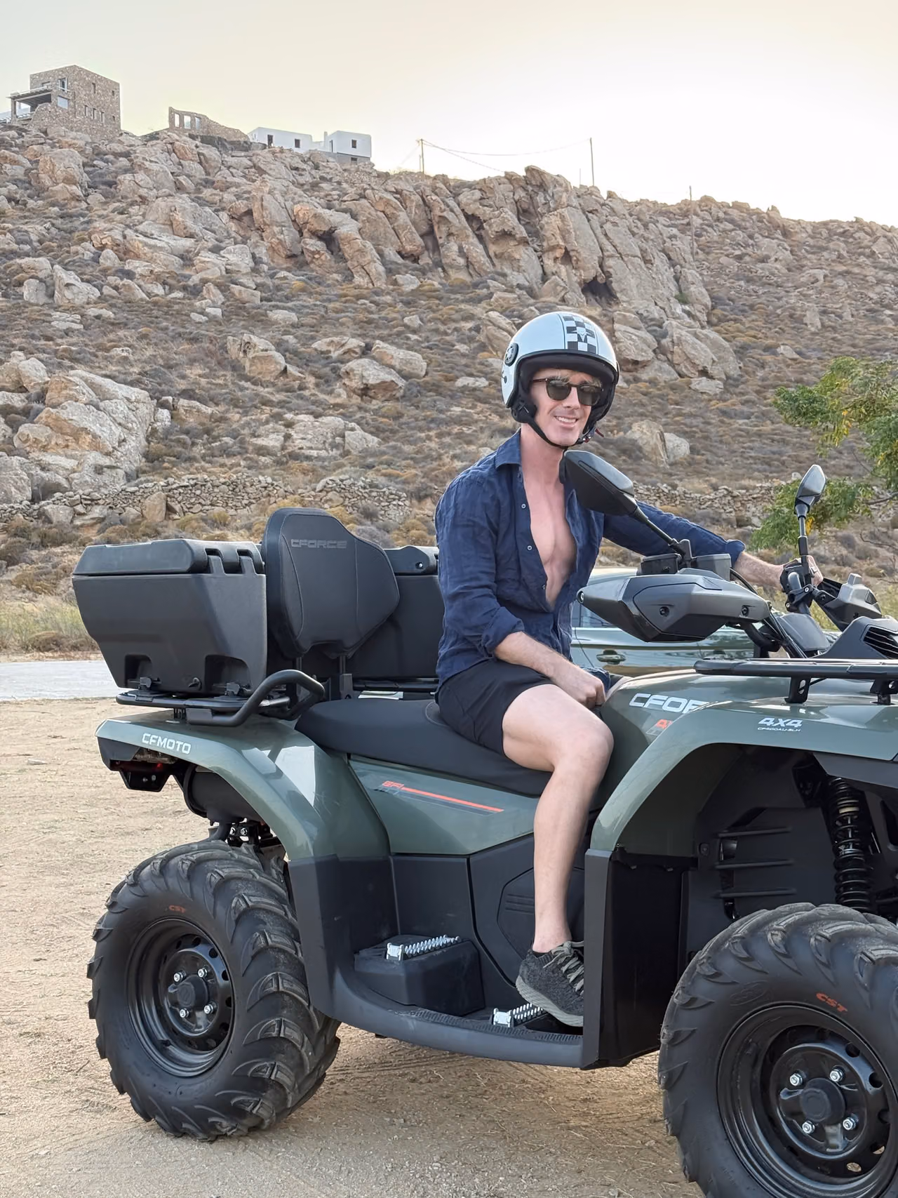 Beatus sitting on our parked rental ATV in Mykonos.