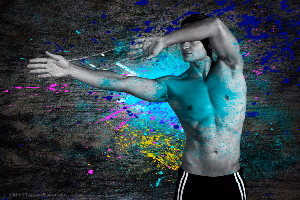 Shirtless man stretching his arms, digitally tinted teal with paint splatter effects, an example of a heavy filter
