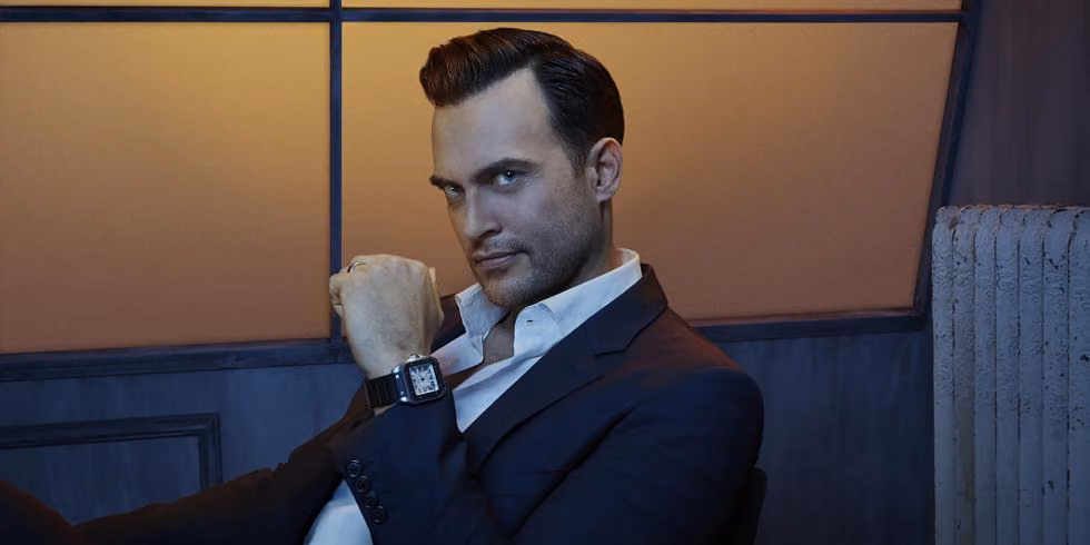 Guest judge Cheyenne Jackson in a dark suit and open-collar white shirt, gazing at the camera
