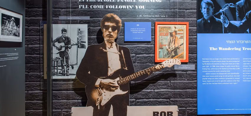 Bob Dylan at 75 exhibit at Beit Hatfutsot: a life-size Dylan cutout with guitar, photos and a Rolling Stone cover
