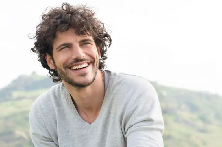 curly hair man smiling